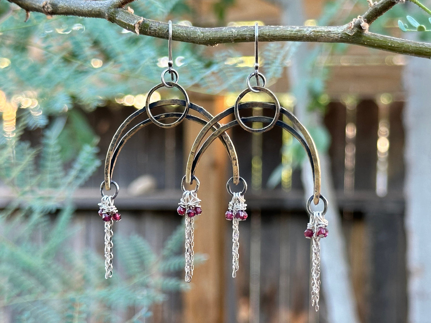 Brass, sterling silver and garnet say Drama Queen.