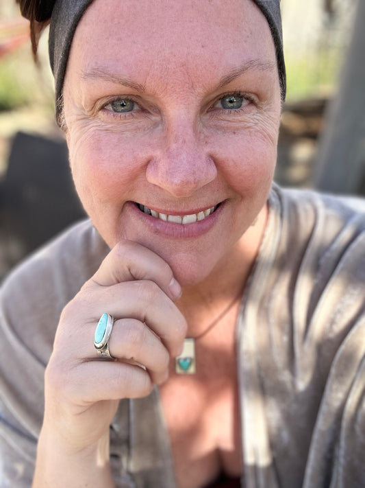 woman facing camera wearing turquoise ring